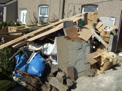 Heavy garden debris and renovation waste awaiting removal